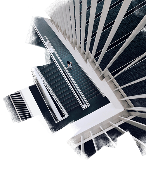 Top view of a woman walking down via stairs inside a huge building